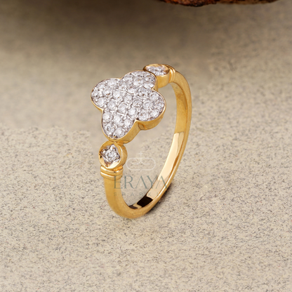 Gold ring with diamond flowers on a beige background