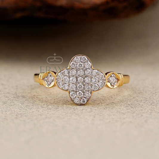 Gold ring with diamond accents on a textured surface, featuring the brand 'ERAYA.'