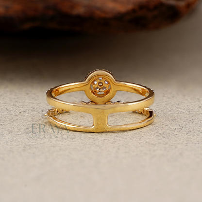 Gold ring with intricate design on a textured surface
