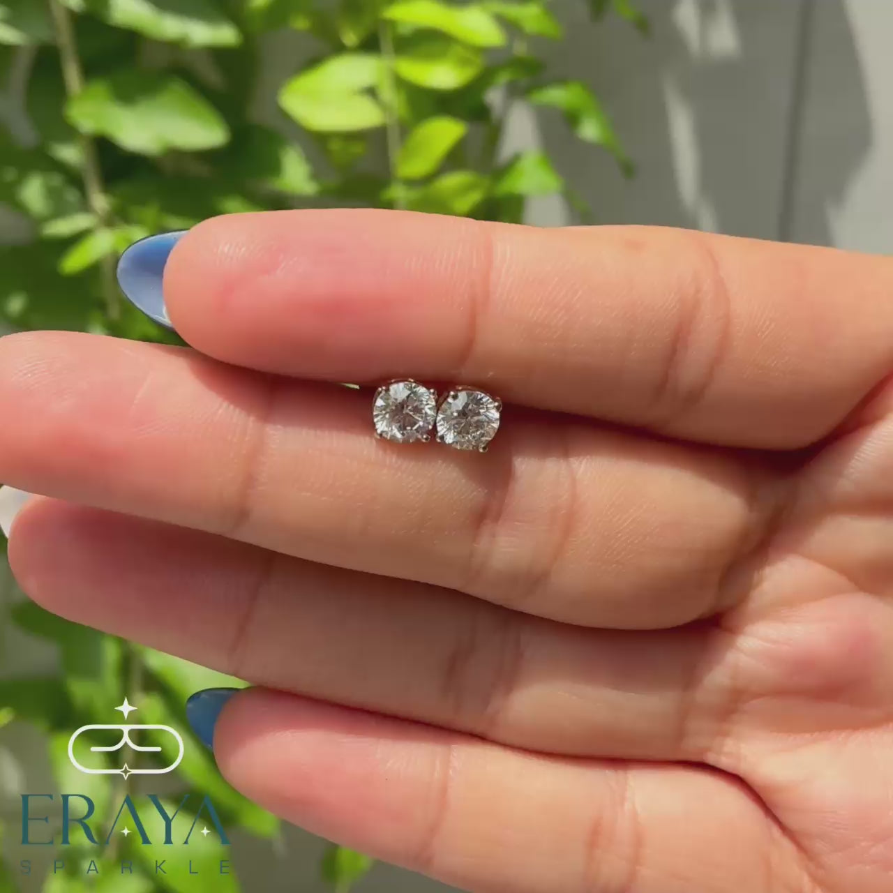 eraya-solitaire-studs-model-hand-wearing-view